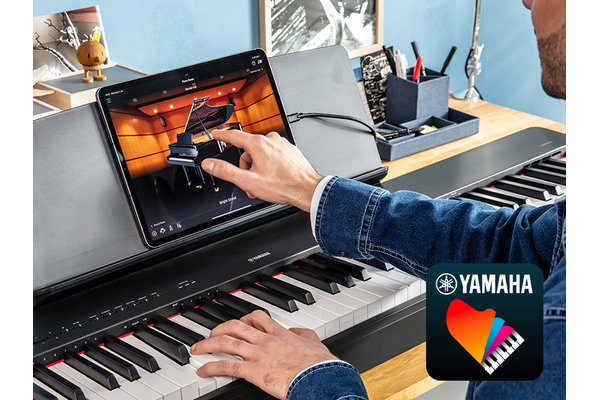 The Yamaha “Smart Pianist” app icon, together with a tablet placed on the music stand of the P-223